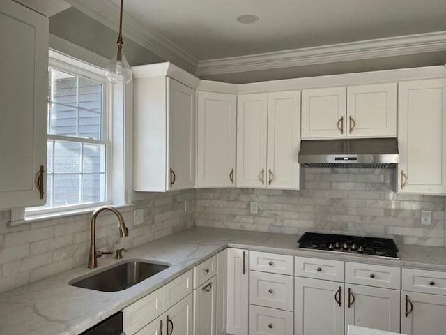 kitchen featuring sink, white cabinetry, gas cooktop, and tasteful backsplash