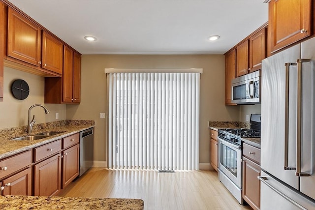 15 Coates Ln Unit 15, Haverhill, MA 01835 - kitchen with appliances with stainless steel finishes, a sink, light wood finished floors, light stone countertops, and recessed lighting