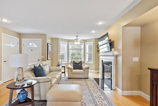 15 Coates Ln Unit 15, Haverhill, MA 01835 - living room with light wood-type flooring, baseboards, a glass covered fireplace, a ceiling fan, and recessed lighting