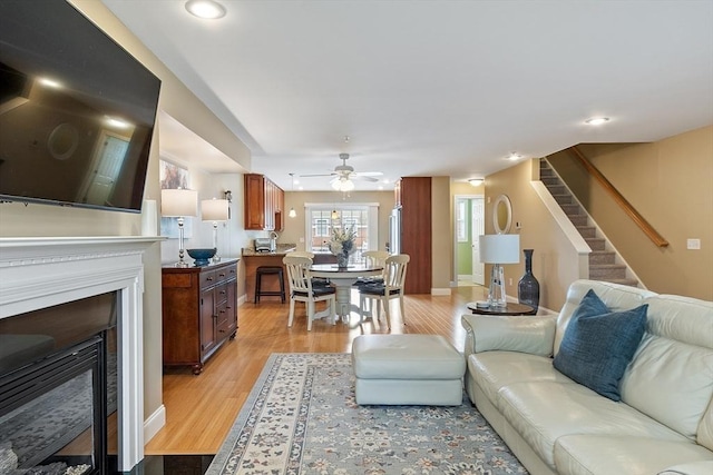 15 Coates Ln Unit 15, Haverhill, MA 01835 - living room featuring a fireplace with flush hearth, light wood-style floors, stairway, ceiling fan, and recessed lighting