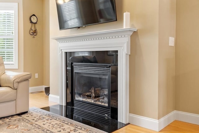 15 Coates Ln Unit 15, Haverhill, MA 01835 - detailed view of a tile fireplace, wood finished floors, and baseboards