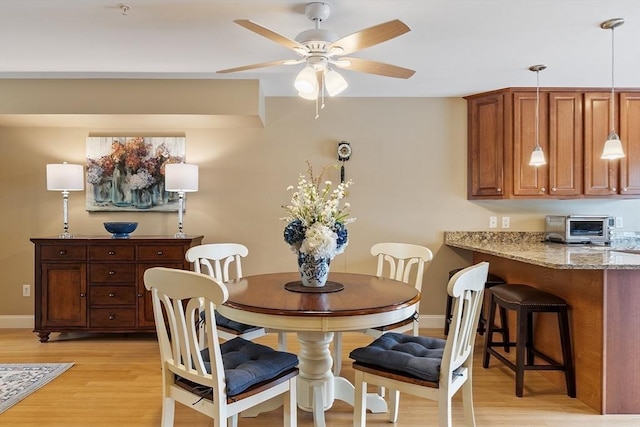 15 Coates Ln Unit 15, Haverhill, MA 01835 - dining area featuring light wood finished floors, ceiling fan, and baseboards