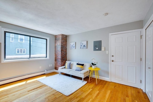 7 Mortimer Pl Unit 6, Somerville, MA 02145 - sitting room featuring light wood finished floors, a baseboard radiator, and electric panel