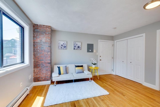 7 Mortimer Pl Unit 6, Somerville, MA 02145 - living area with a baseboard radiator, healthy amount of natural light, and light wood-style flooring
