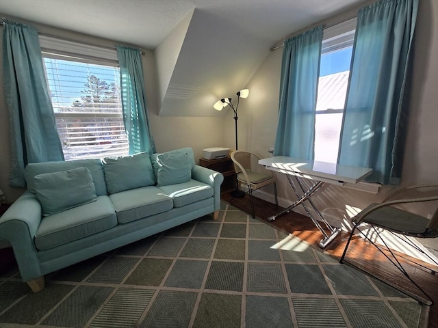 living room featuring plenty of natural light and lofted ceiling