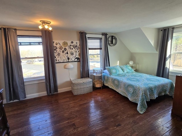 bedroom with vaulted ceiling, baseboards, and hardwood / wood-style floors