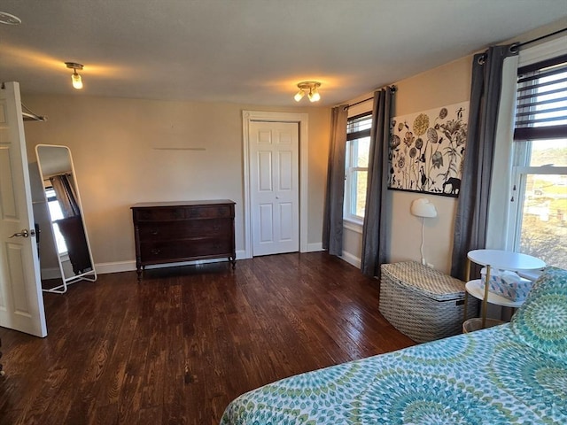 bedroom with wood finished floors and baseboards