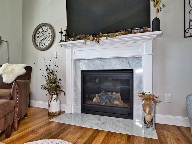 interior details with a high end fireplace and dark wood-type flooring