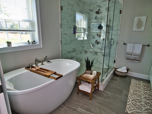 bathroom with separate shower and tub, tile floors, and a wealth of natural light