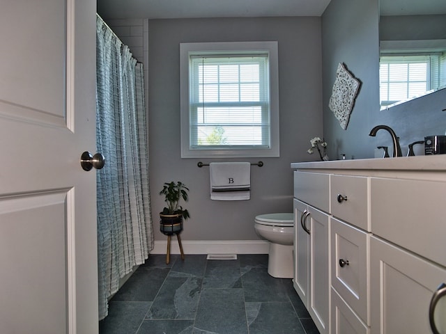 bathroom featuring tile flooring, a wealth of natural light, and toilet