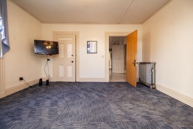 interior space featuring dark colored carpet and radiator heating unit