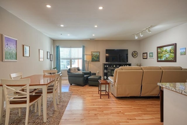 living room with light wood-style floors, visible vents, and recessed lighting