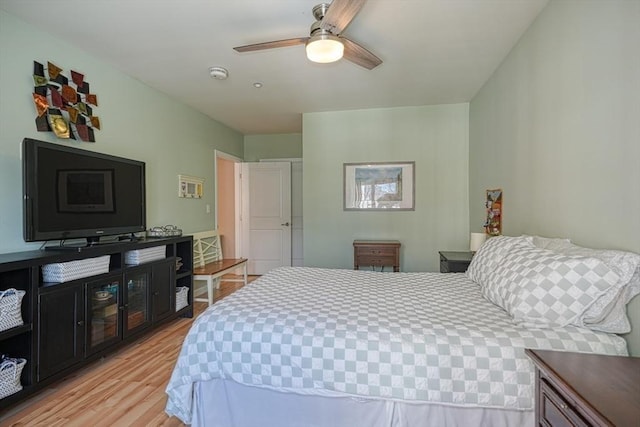 bedroom with a ceiling fan and light wood-style floors