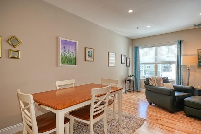 dining room with recessed lighting, light wood-style flooring, and baseboards