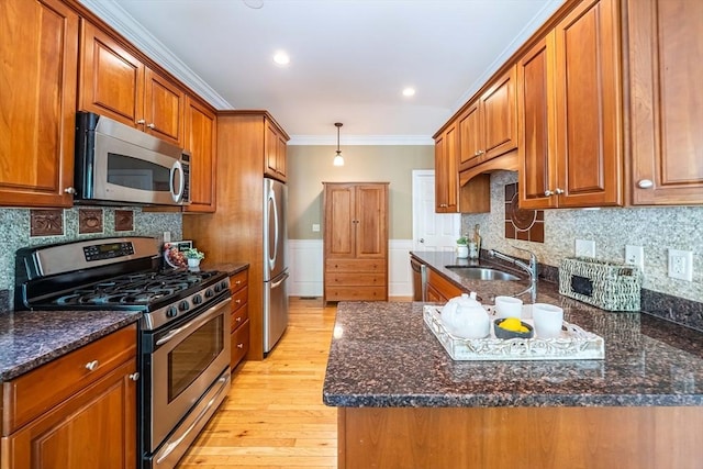 745-A Massachusetts Ave Unit A, Arlington, MA 02476 - kitchen with stainless steel appliances, a sink, brown cabinets, light wood-type flooring, and crown molding