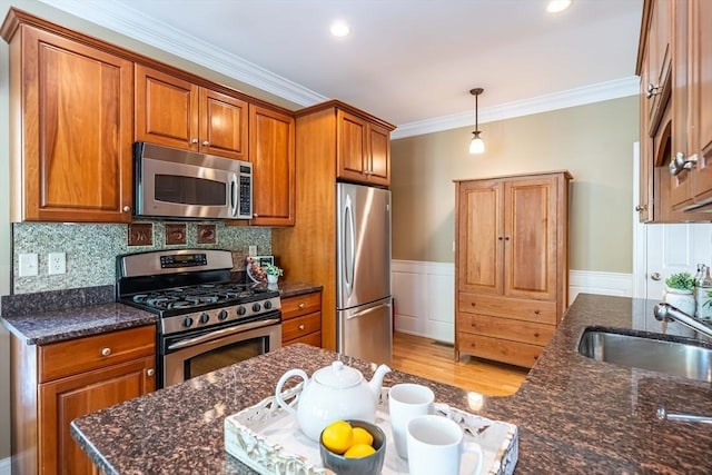 745-A Massachusetts Ave Unit A, Arlington, MA 02476 - kitchen with stainless steel appliances, a sink, brown cabinets, crown molding, and light wood-style flooring