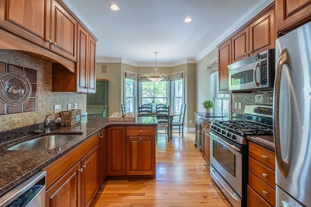 745-A Massachusetts Ave Unit A, Arlington, MA 02476 - kitchen featuring stainless steel appliances, a sink, decorative backsplash, brown cabinetry, and crown molding