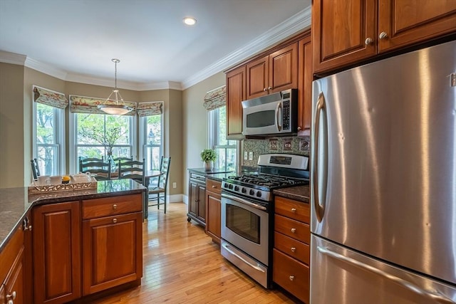 745-A Massachusetts Ave Unit A, Arlington, MA 02476 - kitchen with stainless steel appliances, light wood-style floors, brown cabinets, backsplash, and ornamental molding