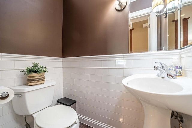 745-A Massachusetts Ave Unit A, Arlington, MA 02476 - half bathroom with toilet, tile walls, wainscoting, and a sink