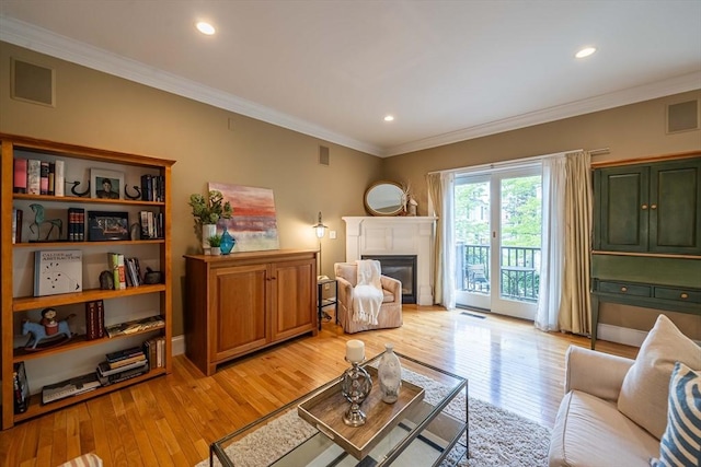 745-A Massachusetts Ave Unit A, Arlington, MA 02476 - living room with light wood-style floors, a glass covered fireplace, ornamental molding, and recessed lighting