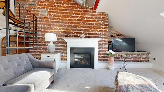 living room featuring carpet floors, brick wall, and vaulted ceiling