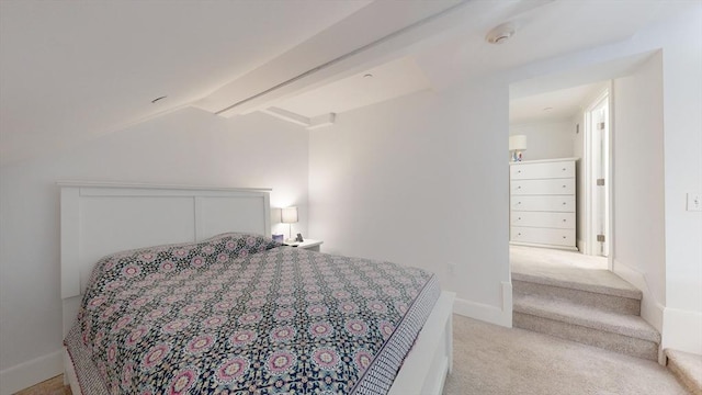 carpeted bedroom featuring lofted ceiling with beams