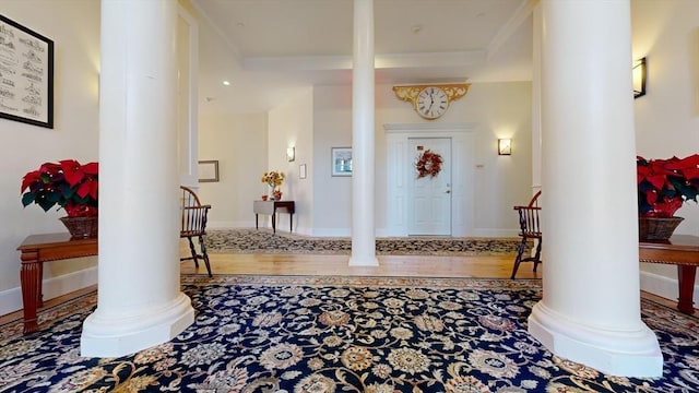 interior space with ornamental molding and decorative columns