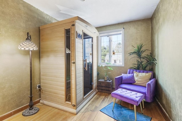 sitting room with wood finished floors and baseboards