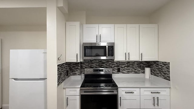 kitchen with appliances with stainless steel finishes, white cabinetry, and light countertops