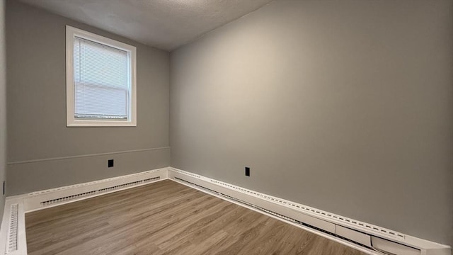 unfurnished room with wood finished floors