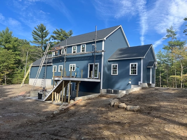 rear view of property with central AC unit and a deck