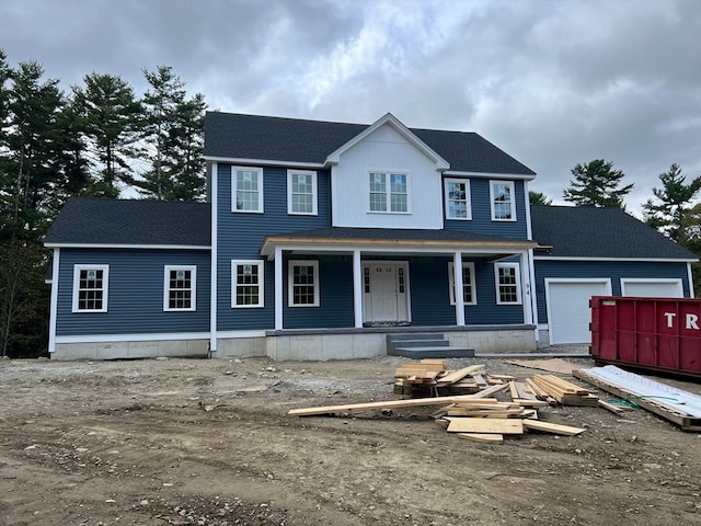 view of front of property featuring covered porch and a garage