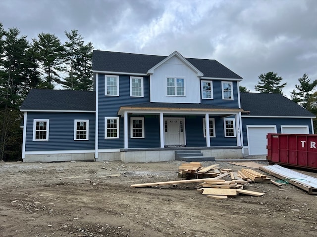 view of front of property with a porch and a garage