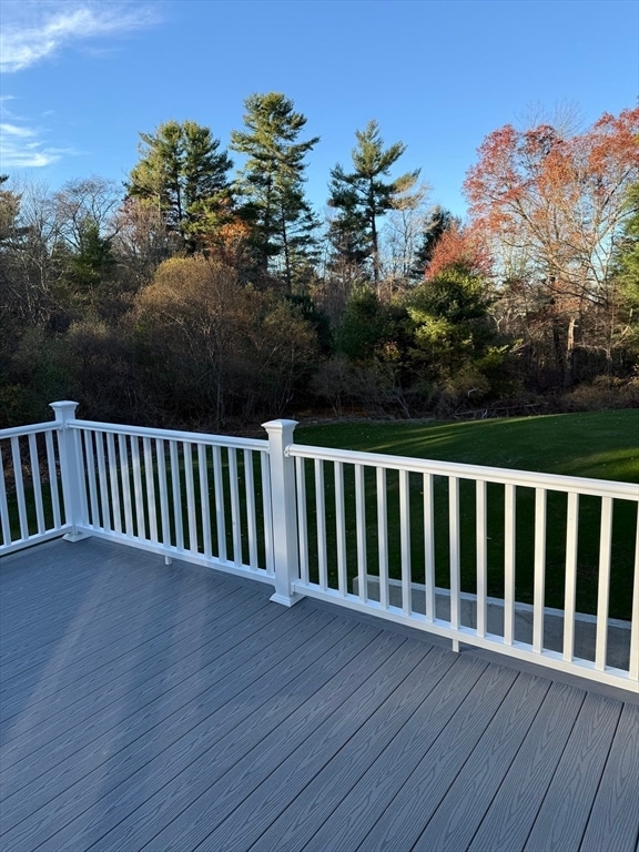 wooden terrace with a lawn