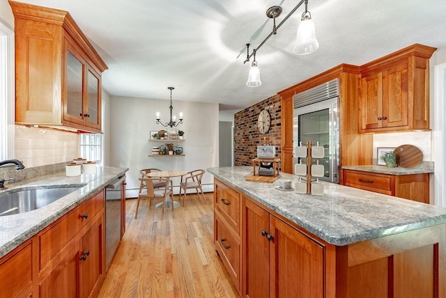 759 Williams St, Longmeadow, MA 01106 - kitchen with refrigerator, light wood-style floors, brown cabinets, glass insert cabinets, and light stone countertops