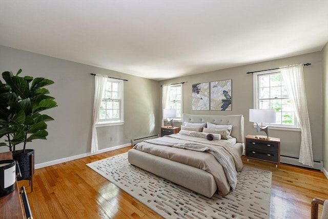 759 Williams St, Longmeadow, MA 01106 - bedroom featuring multiple windows, baseboard heating, and light wood-style floors