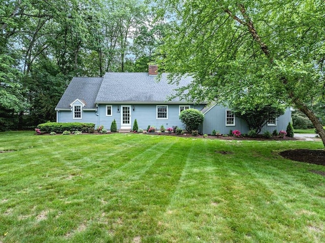 759 Williams St, Longmeadow, MA 01106 - view of front of house featuring a chimney, a front lawn, and entry steps