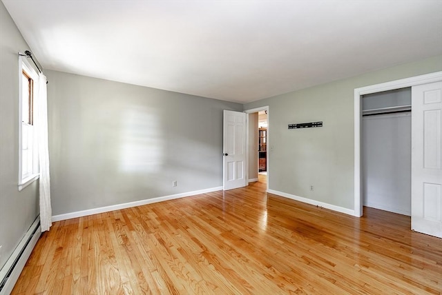 759 Williams St, Longmeadow, MA 01106 - unfurnished bedroom with a baseboard heating unit, light wood-style floors, and a closet