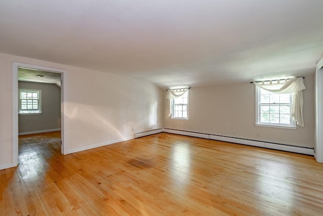 759 Williams St, Longmeadow, MA 01106 - empty room featuring a baseboard heating unit, plenty of natural light, and light wood-style flooring