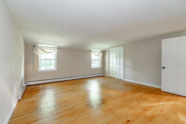 759 Williams St, Longmeadow, MA 01106 - empty room featuring a baseboard radiator, plenty of natural light, and light wood-style flooring