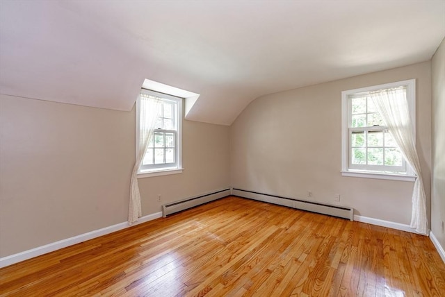 759 Williams St, Longmeadow, MA 01106 - additional living space with a baseboard radiator, light wood-type flooring, and vaulted ceiling