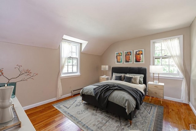 759 Williams St, Longmeadow, MA 01106 - bedroom featuring multiple windows, wood finished floors, vaulted ceiling, and a baseboard radiator
