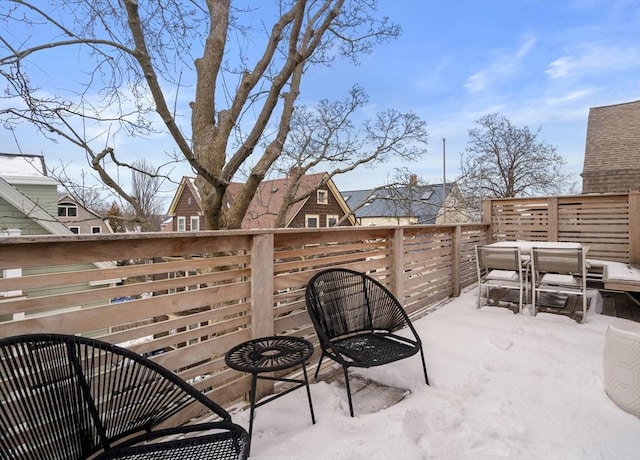 snow covered patio featuring outdoor dining area