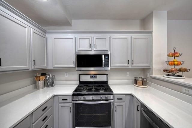 kitchen with light countertops and appliances with stainless steel finishes