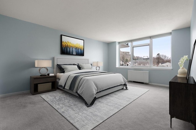 carpeted bedroom featuring radiator