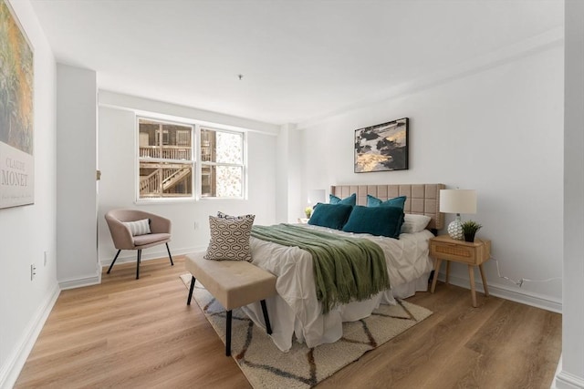 bedroom featuring baseboards and light wood-style floors