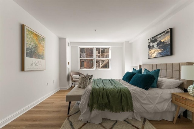 bedroom with wood finished floors and baseboards