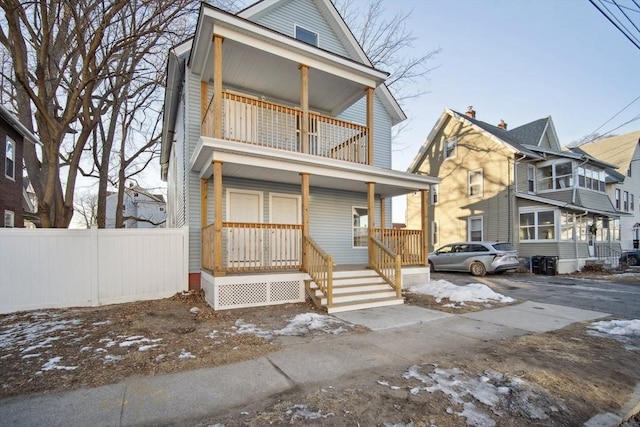 view of front facade with a balcony and a porch