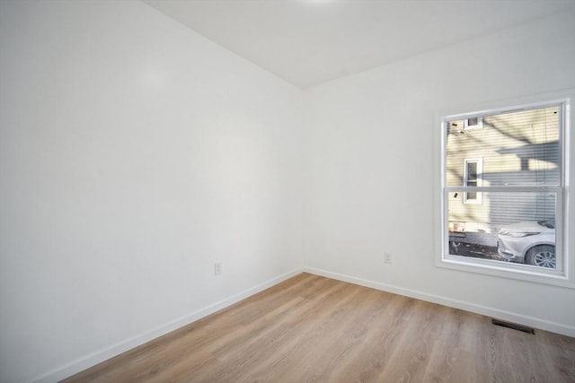 spare room featuring light hardwood / wood-style floors