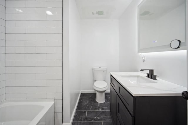 full bathroom with vanity, tiled shower / bath, and toilet